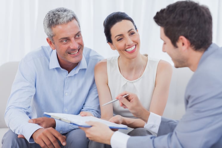 Business people talking together on sofa at office